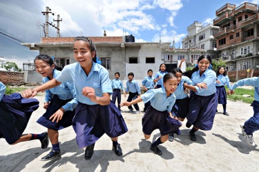 Girls running at school in Nepal. Credit: Ken Opprann/Norad
