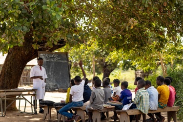 Children sit outside at Inlima Primary School after Cyclone Freddy destroyed it. Mozambique. Credit: GPE/Mbuto Machili