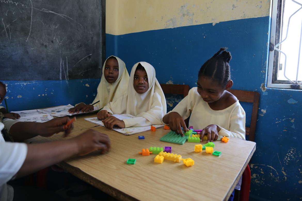 Some of the children who need additional support sit together in a smaller classroom.