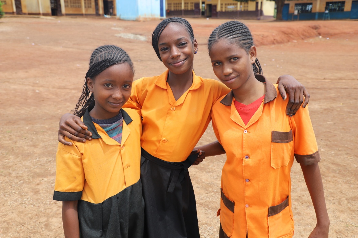 Schoolgirls in uniform bonding during lunch break at Public Primary School Bindia in the East region of Cameroon. Credit: World Bank/O. Hebga