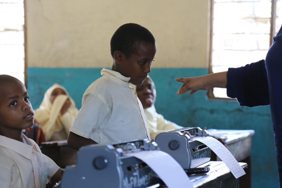 The teacher asks Mahmoudou to stand up and answer a question about the 5 sense organs. The teacher asks Mahmoudou to stand up and answer a question about the 5 sense organs.